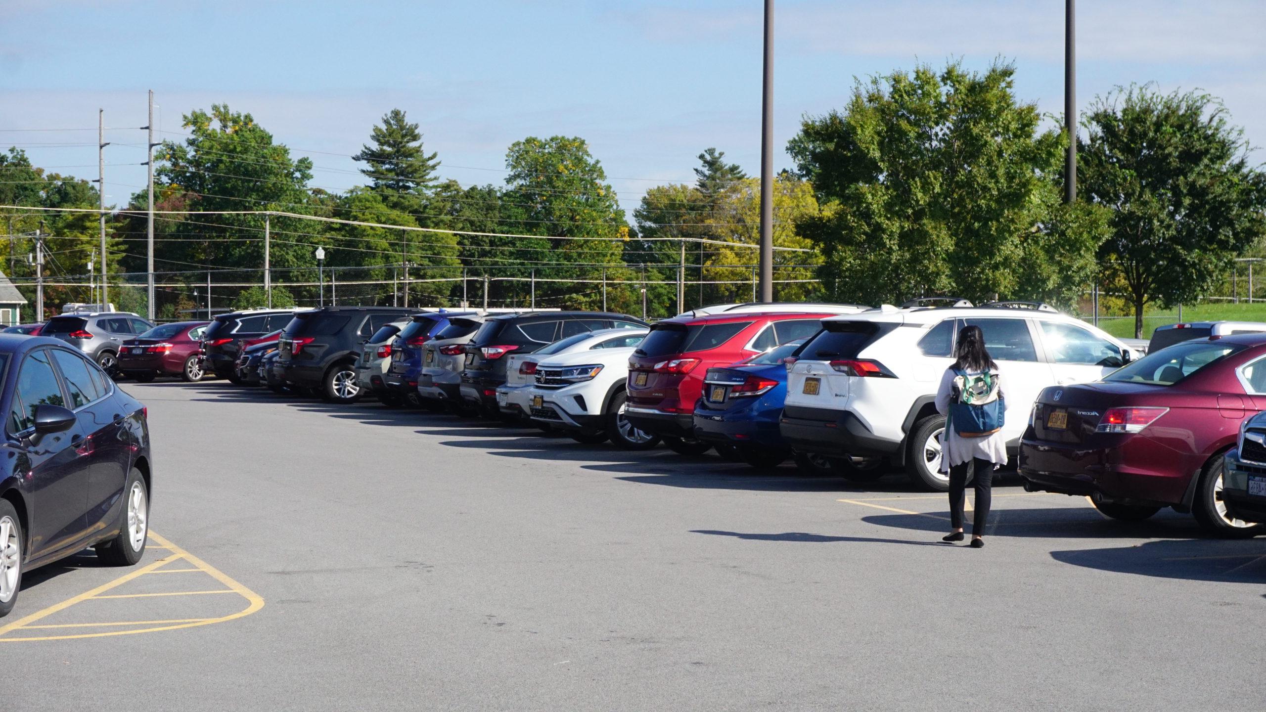 Student walking to vehicle in UR parking lot.