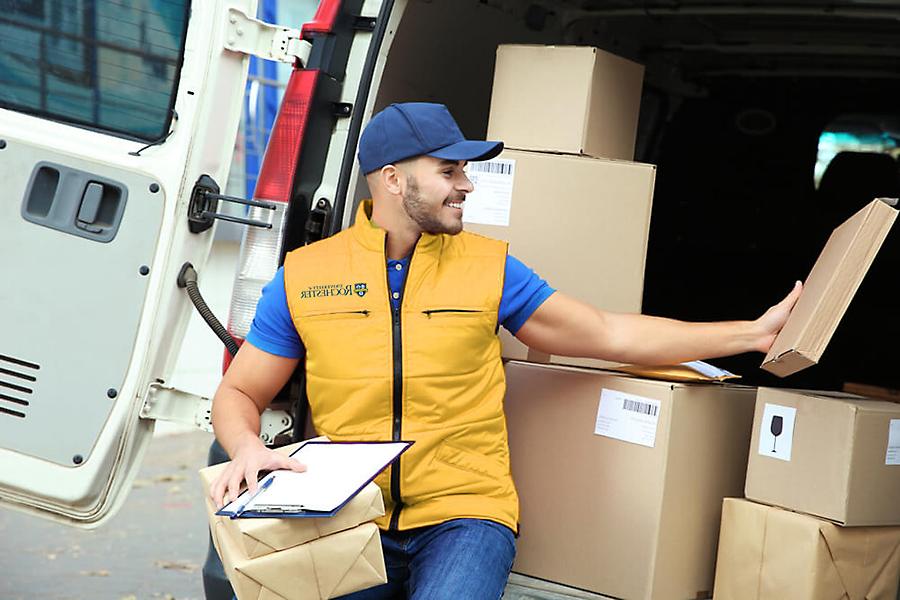 Employee loading boxes onto truck.